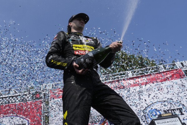 Colton Herta, of the United States, celebrates with his team after winning an IndyCar auto race in Toronto, Sunday, July 21, 2024. (Frank Gunn/The Canadian Press via AP)