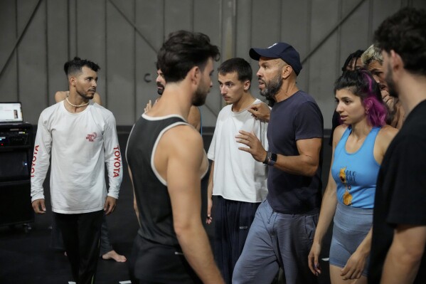 French-Algerian choreographer Mourad Merzouki guides his dancers as they rehearse for "Dance of the Games" at the concert hall in Creteil, east of Paris, Wednesday July 31, 2024. Merzouki is bringing hip-hop dance to the Paris Olympics. The French-Algerian choreographer is the creator of the “Dance of the Games.” Merzouki's showcase at the Trocadéro Champions Park kicks off Monday Aug. 5, 2024. (AP Photo/Michel Euler)