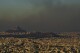 A general view of Athens with the Acropolis hill is seen as fire burns the northern part of the city on Monday, Aug. 12, 2024, Hundreds of firefighters are tackling a major wildfire raging out of control on the fringes of the Greek capital. (AP Photo/Petros Giannakouris)