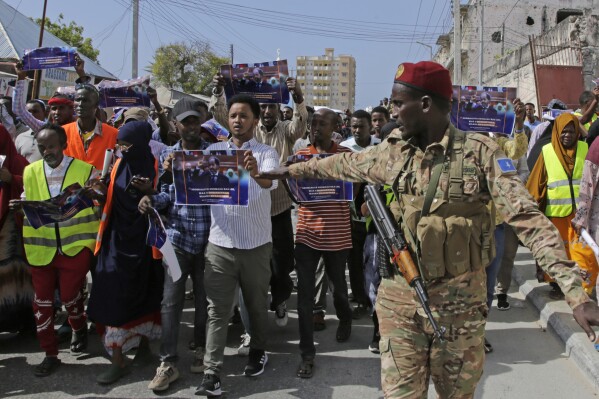 FILE - A Somali soldier controls the crowd as thousands of people attend a protest rally in Mogadishu, Somalia, Wednesday Jan.3, 2024, after being angry with an agreement signed between Ethiopia and the breakaway region of Somaliland to give landlocked Ethiopia access to its shoreline. (AP Photo/Farah Abdi Warsameh, File)