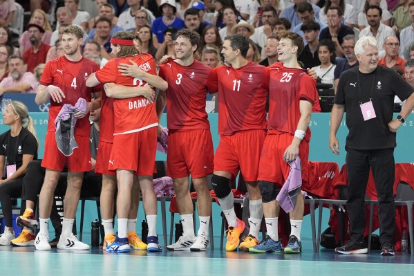 Denmark players celebrate after a goal during the gold medal handball match between Germany and Denmark at the 2024 Summer Olympics, Sunday, Aug. 11, 2024, in Villeneuve-d'Ascq, France. (AP Photo/Aaron Favila)