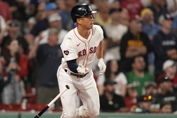 Boston Red Sox's Rob Refsnyder watches his winning RBI single in the 10th inning of a baseball game against the Texas Rangers at Fenway Park, Monday, Aug. 12, 2024, in Boston. (AP Photo/Charles Krupa)