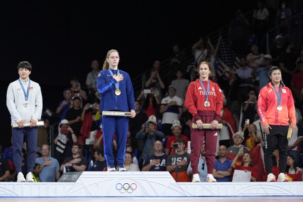 Medalists, from left, Kyrgyzstan's Meerim Zhumanazarova, silver, United State's Amit Elor, gold, Turkey's Buse Tosun Cavusoglu, Japan's Nonoka Ozaki, bronze, pose during the medal ceremony for women's freestyle 68kg wrestling, at Champ-de-Mars Arena, during the 2024 Summer Olympics, Tuesday, Aug. 6, 2024, in Paris, France. (AP Photo/Eugene Hoshiko)