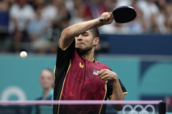 United States' Kanak Jha plays against Greece's Panagiotis Gionis during a men's singles round of 32 table tennis game at the 2024 Summer Olympics, Wednesday, July 31, 2024, in Paris, France. (AP Photo/Petros Giannakouris)