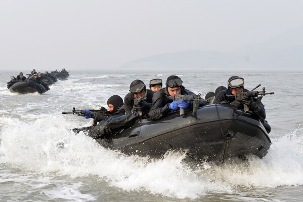 FILE - South Korean and United States marines ride on inflatable boats during a joint landing exercise to prepare for a possible North Korea's surprise attack in waters off Ganghwa Island, located inside of the civilian passage restriction line that separates the two Koreas since the Korean War, South Korea, Feb. 10, 2015. (Yonhap via AP, File)