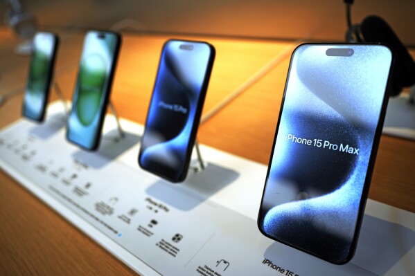 FILE - Apple iPhone 15 ProMax phones are shown in an Apple store in Pittsburgh, on June 3, 2024. Apple reports earnings on Thursday, Aug. 1, 2024. (AP Photo/Gene J. Puskar, File)