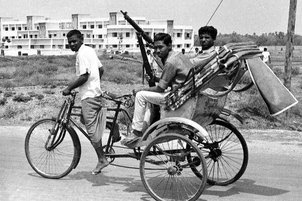 FILE - In this April 2, 1971, file photo, armed East Pakistan fighters head for the battle front by pedicab, in Jessore, East Pakistan. (AP Photo, File)