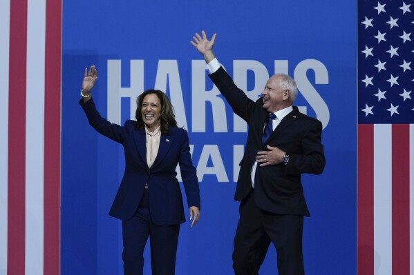 Democratic presidential nominee Vice President Kamala Harris and her running mate Minnesota Gov. Tim Walz arrive at a campaign rally in Philadelphia, Tuesday, Aug. 6, 2024. (AP Photo/Matt Rourke)