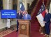 Undue Medical Debt board member Jose N. Penabad, center, speaks, while Gov. Roy Cooper, left, and state Health and Human Services Secretary Kody Kinsley listen on Monday, Aug. 12, 2024, at the Executive Mansion in Raleigh, N.C. (AP Photo/Gary D. Robertson)