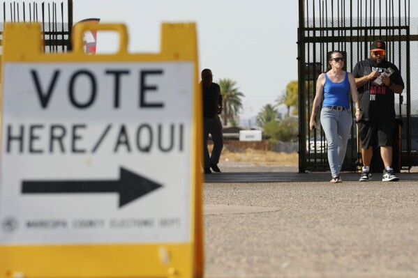 Voters walk to a voting station to cast their votes Tuesday, July 30, 2024, in Guadalupe, Ariz. (AP Photo/Ross D. Franklin)