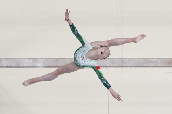 Zhou Yaqin, of China, performs on the beam during the women's artistic gymnastics individual balance beam finals in Bercy Arena at the 2024 Summer Olympics, Monday, Aug. 5, 2024, in Paris, France. (AP Photo/Morry Gash)