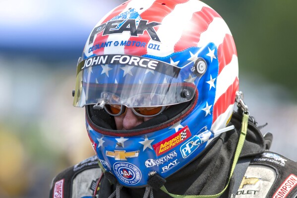 FILE - Funny Car driver John Force prepares to run in the finals at the NHRA Thunder Valley Nationals at Bristol Dragway in Bristol, Tenn., on June 16, 2019. Force has been discharged from the hospital where he was undergoing rehabilitation for a traumatic brain injury sustained in a fiery, 300-mph crash at the Virginia Nationals last month, according to a statement released on Tuesday, July 23, 2024.. (David Crigger/Bristol Herald Courier via AP, File)