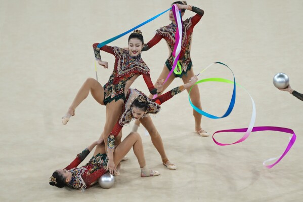 Team China performs with ribbons and balls in the group all-around rhythmic gymnastics final at La Chapelle Arena during the 2024 Summer Olympics, Saturday, Aug. 10, 2024, in Paris, France. (AP Photo/Dar Yasin)