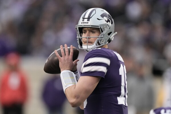 FILE - Then-0Kansas State quarterback Will Howard looks to pass during the second half of the team's NCAA college football game against Baylor, Nov. 11, 2023, in Manhattan, Kan. (AP Photo/Charlie Riedel, File)