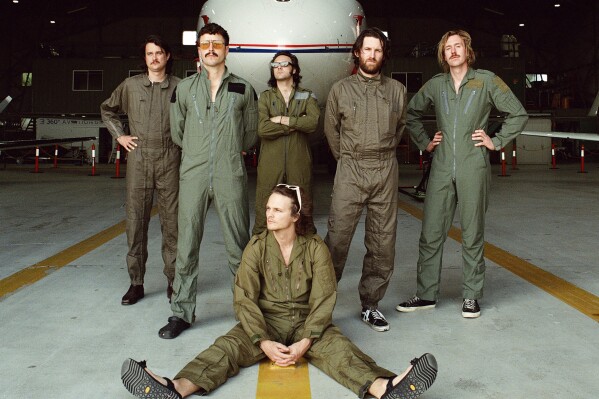 This undated promotional photo shows members of the Australian rock band King Gizzard & the Lizard Wizard, Stu Mackenzie, foreground, and standing from left, Ambrose Kenny-Smith, Joey Walker, Michael Cavanagh, Lucas Harwood, and Cook Craig. (Maclay Heriot via AP)