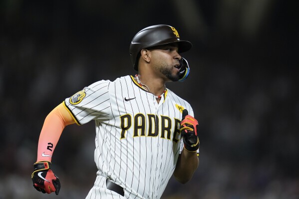 San Diego Padres' Xander Bogaerts watches his RBI single during the seventh inning of a baseball game against the Pittsburgh Pirates, Monday, Aug. 12, 2024, in San Diego. (AP Photo/Gregory Bull)