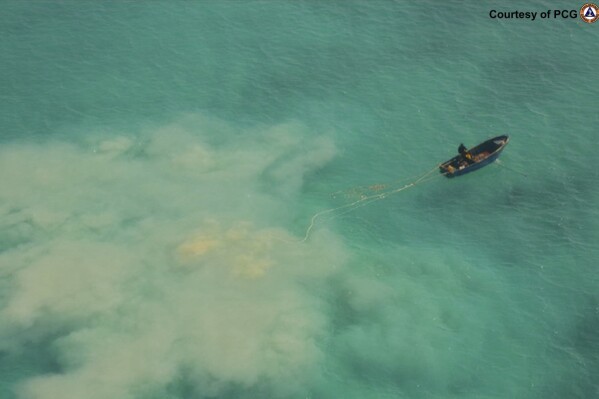 FILE - In this photo provided by the Philippine Coast Guard, a Chinese service boat scours the seabed as they search for giant clams in the Scarborough Shoal, at the disputed South China Sea, on April 22, 2019. (Philippine Coast Guard via AP)