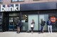 FILE — People line up outside the Blink Fitness gym, March 26, 2021, in the Lower East Side neighborhood of New York. (AP Photo/Mary Altaffer, File)