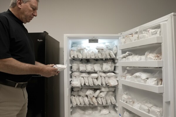 David Ayares, president and chief scientific officer of Revivicor, holds a package of frozen meat during an interview at the company’s offices in Blacksburg, Va., on May 30, 2024. His company genetically modified pigs, known as GalSafe pigs, so they no longer carry a sugar responsible for alpha-gal syndrome, an allergy to red meat. (AP Photo/Shelby Lum)