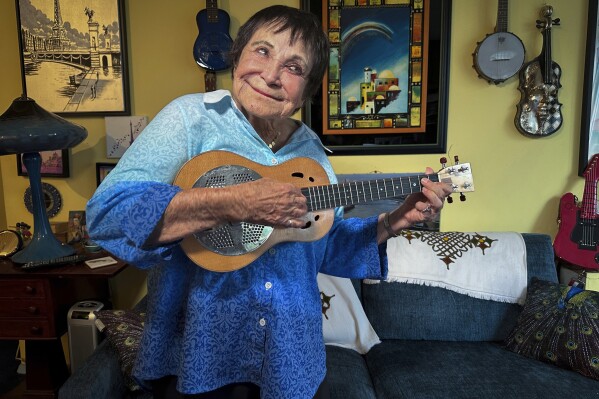 FILE - D'yan Forest, 89, who holds the Guinness World Record for Oldest Working Female Comedian, poses in her apartment, Thursday, July 19, 2024, in New York. Forest is recovering after being randomly punched and knocked to the ground while waiting to cross a street in New York earlier this month.(AP Photo/Ted Shaffrey, File)