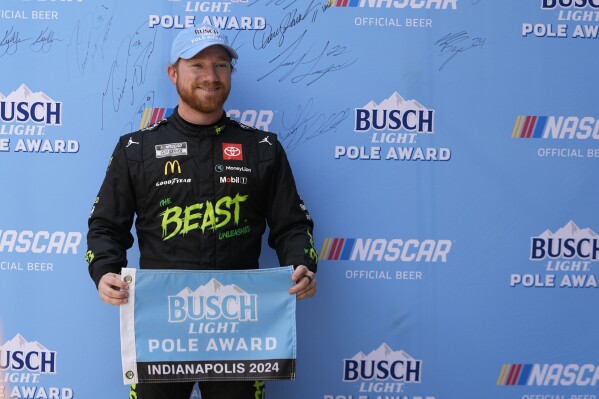 Tyler Reddick holds the pole award for the NASCAR Cup Series auto race at Indianapolis Motor Speedway, Saturday, July 20, 2024, in Indianapolis. (AP Photo/Darron Cummings)