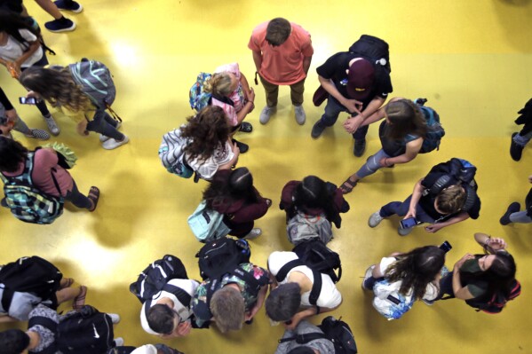 FILE - Students gather in a common area as they head to classes in Oregon, May 4, 2017. (AP Photo/Don Ryan, File)