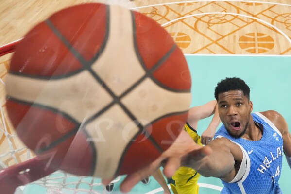 Giannis Antetokounmpo, of Greece, gets a lay-up against Australia in a men's basketball game at the 2024 Summer Olympics, Friday, Aug. 2, 2024, in Villeneuve-d'Ascq, France. (AP Photo/Mark J. Terrill, Pool)