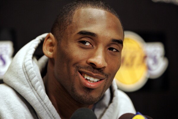 FILE - Los Angeles Lakers basketball star Kobe Bryant smiles as he talks about his 81-point game Jan. 22, 2006, against the Toronto Raptors at Lakers headquarters in El Segundo, Calif., Jan. 24, 2006. A statue of Bryant and his daughter, Gigi Bryant, was scheduled to be unveiled during a private ceremony on Friday, Aug. 2, 2024 according to a published report. (AP Photo/Reed Saxon, File)