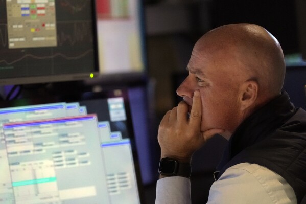 Specialist John O'Hara works at his post on the floor of the New York Stock Exchange, Wednesday, Aug. 7, 2024. (AP Photo/Richard Drew)