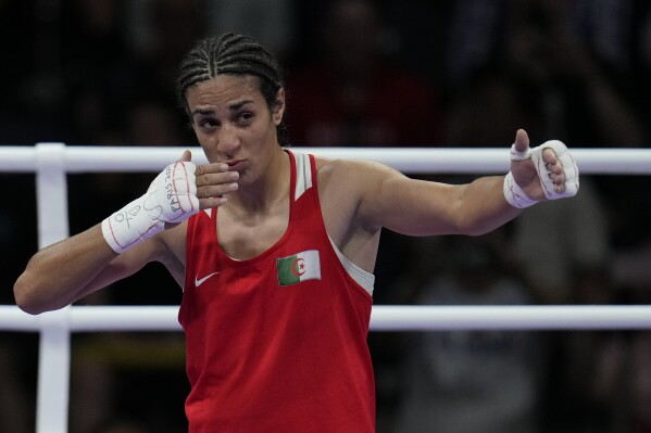 Algeria's Imane Khelif, celebrates after defeating Hungary's Anna Hamori in their women's 66kg quarterfinal boxing match at the 2024 Summer Olympics, Saturday, Aug. 3, 2024, in Paris, France. (AP Photo/John Locher)