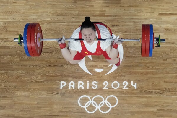 Li Wenwen of China competes during the women's +81kg weightlifting event at the 2024 Summer Olympics, Sunday, Aug. 11, 2024, in Paris, France. (AP Photo/Dita Alangkara,Pool)