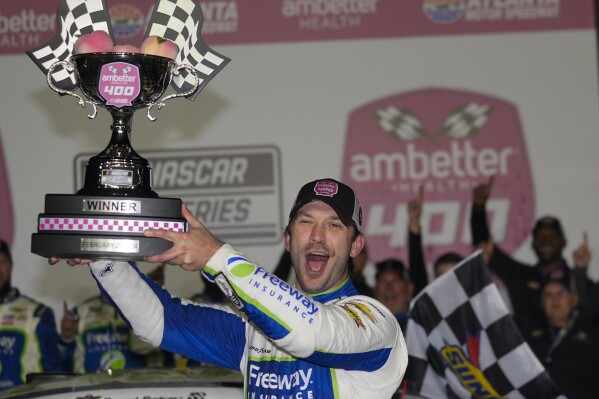 FILE - Daniel Suarez holds the trophy after winning the NASCAR auto race at Atlanta Motor Speedway Sunday, Feb. 25, 2024, in Hampton , Ga. NASCAR Cup Series driver Daniel Suarez will compete next month in the sanctioning body's Brasil Series Special Edition tournament that runs parallel to its main competition in Brazil.(AP Photo/John Bazemore, File)