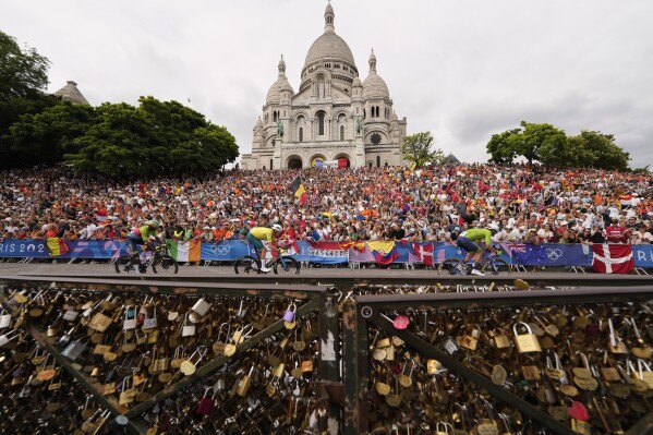 Cyclists ride past the Sacre Coeur basilica, during the men's road cycling event, at the 2024 Summer Olympics, Saturday, Aug. 3, 2024, in Paris, France. (AP Photo/Vadim Ghirda)