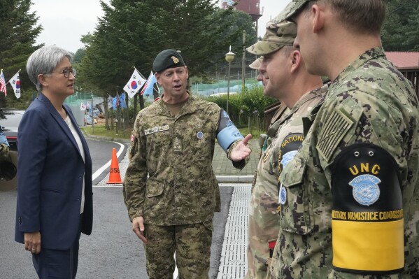 Australian Foreign Minister Penny Wong, left, is escorted by UNC DCDR Derek Allen Macaulay, second from left, before visiting the truce village of Panmunjom in the Demilitarized Zone (DMZ) on the border between North and South Korea, at the JSA Visitor Center in Paju, South Korea, Tuesday, July 30, 2024. (AP Photo/Ahn Young-joon)