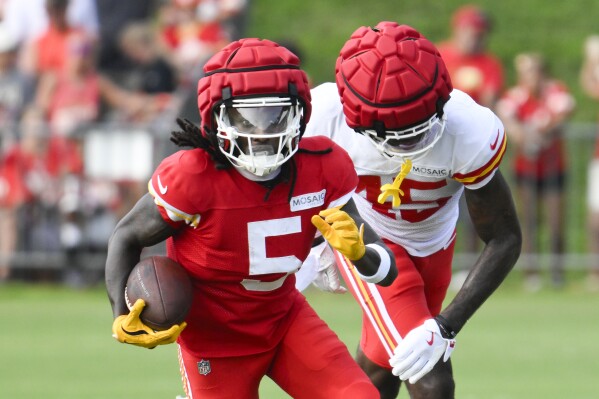 Kansas City Chiefs wide receiver Marquise "Hollywood" Brown (5) runs after a catch as cornerback Miles Battle (45) defends during NFL football training camp Saturday, July 27, 2024, in St. Joseph, Mo. (AP Photo/Reed Hoffmann)