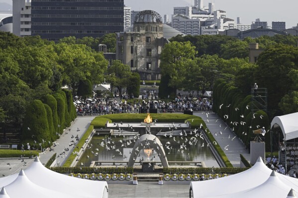 Doves fly over the cenotaph dedicated to the victims of the atomic bombing during an annual ceremony marking the 79th anniversary of the world's first atomic bombing, at the Peace Memorial Park in Hiroshima, western Japan, Tuesday, Aug. 6, 2024. (Yu Nakajima/Kyodo News via AP)