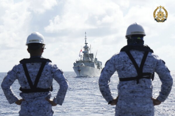 In this handout photo provided by Public Affairs Office Armed Forces of the Philippines, Philippine Navy personnel watch the Canadian vessel HMCS Montreal (FFH336) during the Multilateral Maritime Cooperative Activity being held in the West Philippine Sea, on Wednesday, Aug. 7, 2024. (Private First Class Carmelotes/Public Affairs Office Armed Forces of the Philippines via AP)