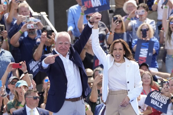 Democratic presidential nominee Vice President Kamala Harris is welcomed by Democratic vice presidential nominee Minnesota Gov. Tim Walz, before she delivers remarks at a campaign event, Wednesday, Aug. 7, 2024, in Eau Claire, Wisc. (AP Photo/Charles Rex Arbogast)