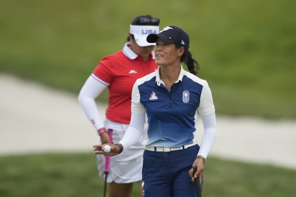 Celine Boutier, of France, acknowledges the crowd after putting on the 14th green during the first round of the women's golf event at the 2024 Summer Olympics, Wednesday, Aug. 7, 2024, at Le Golf National, in Saint-Quentin-en-Yvelines, France. (AP Photo/Matt York)