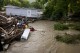 A mobile home swept from its foundation is seen lodged about 1,000 feet away from the property where it stood near a bridge on the Canisteo River, Friday, Aug. 9, 2024, in Canisteo, N.Y., after remnants of Tropical Storm Debby swept through the area. (AP Photo/Craig Ruttle)