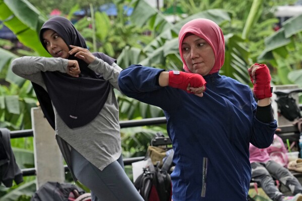  Rani Miranti, right, practices martial arts with self-defense instructor Rahimatul Hasanah at a public park in Jakarta, Indonesia. (AP Photo/Achmad Ibrahim)