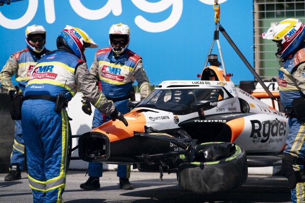 The car of Alexander Rossi is removed from the track following an impact with the barrier that resulted in Rossi breaking his right thumb, during the first practice ahead of the Ontario Honda Dealers Indy Toronto auto race in Toronto, Friday, July 19, 2024. (Arlyn McAdorey/The Canadian Press via AP)