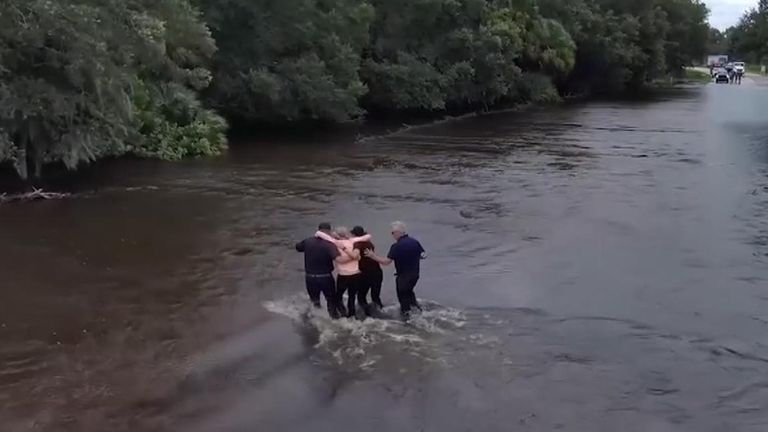 A driver was stuck in swift-moving floodwaters that hit Manatee County in Florida.