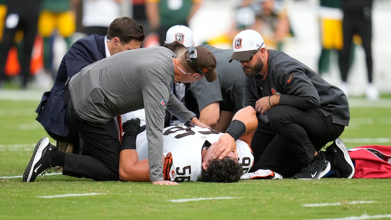 Cleveland Browns medical personnel look over center Luke Wypler during the first half of an...