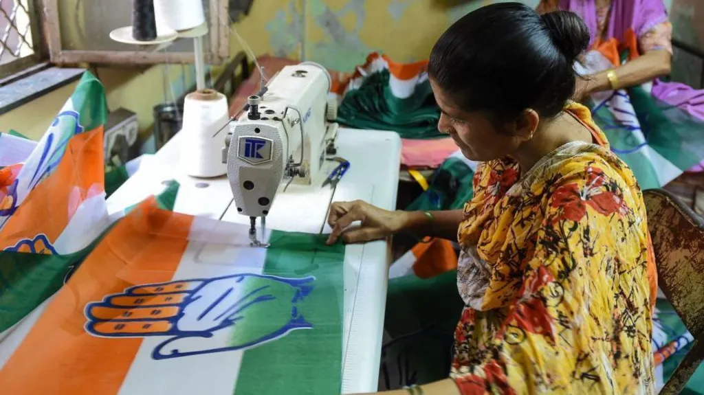 Woman stitches India election material at home