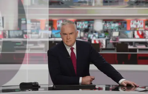 Huw Edwards reading the news