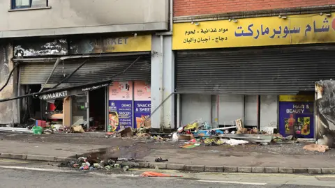 Adjacent shops belonging to ethnic minorities burnt out during recent disorder