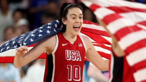 Breanna Stewart celebrates with a US flag