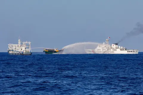 Chinese Coast Guard vessels fire water cannons towards a Philippine resupply vessel