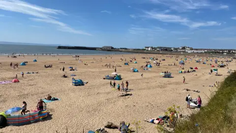 People laying on the sand at the beach